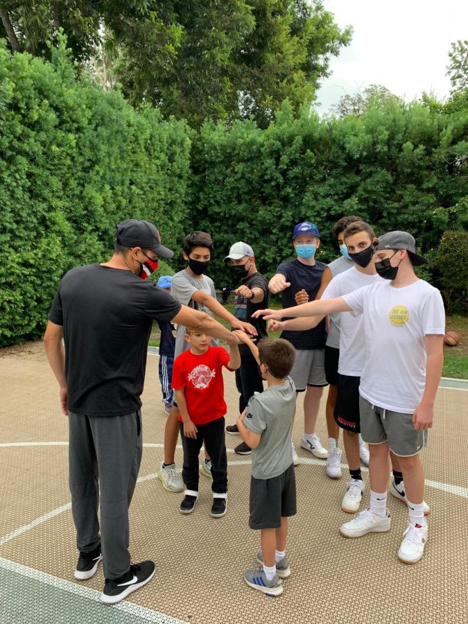 Presidential Service Award winners Matthew G. (22), Matthew L. (22), and other dTHS volunteers help show great sportsmanship during their organizations basketball event benefiting The Boys and Girls Club of Watts in September 2021.