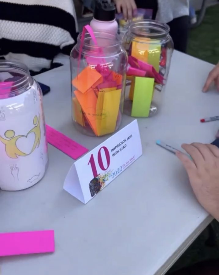Jordyn S. (24) and JLEAD host  a booth for the 5th Annual Mental Health Fair where people write notes of kindness for students to take around the school. 