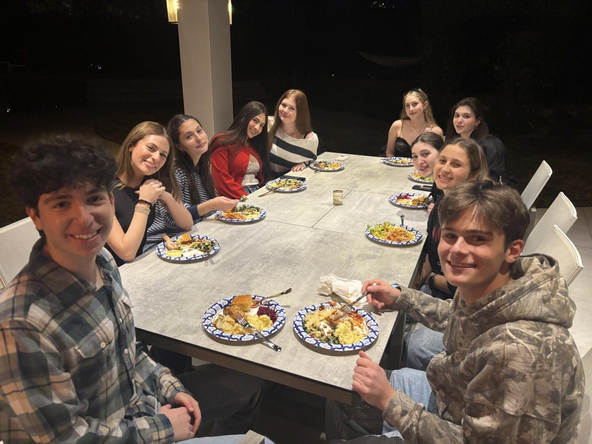 Thirty seniors kick off the holidays at the home of Aaron M. during the senior Friendsgiving dinner. A small group of seniors (clockwise from bottom-left Aaron M, Ella S, Ava B, Elle C, Cami M, Noa B, Olivia F, Madalyn K, Rachel S, Ben R) share a Thanksgiving meal together, Nov. 24, 2024. 