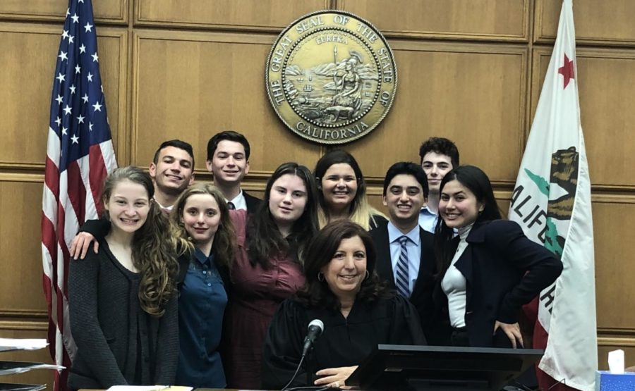 de Toledo's Mock Trial team competed at the Stanley Mosk Courthouse in Los Angeles Nov. 4 and 12. From left to right, with the Honorable Judge center: Ava W. '23, Sydney G. '20, Leah L. '20, Maddy M. '23, Benny G. '21, Shani H. '20 (back row) Spencer S. '21, Dylan S. '22, Ethan B. '23