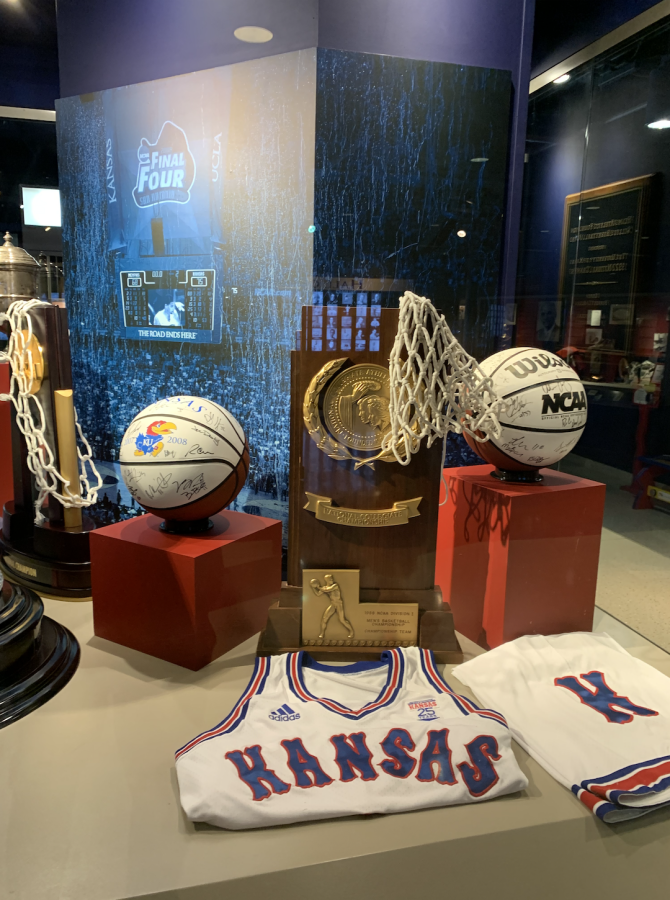 Title tropies from 1988 and 2008 and an autographed basketball from each member of the 2007-2008 team sit in an exhibit at Kansas University.