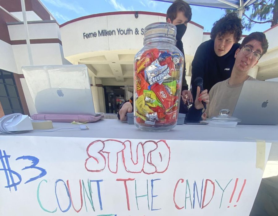 Ninth Grade Student Council members, including (left to right) Ari F. (25) Owen S. (25), and Aaron M. (25) raffled off Six Flags 
tickets in the courtyard May 10, 2022, to help support future student council events by asking students to guess how much candy is in a jar.