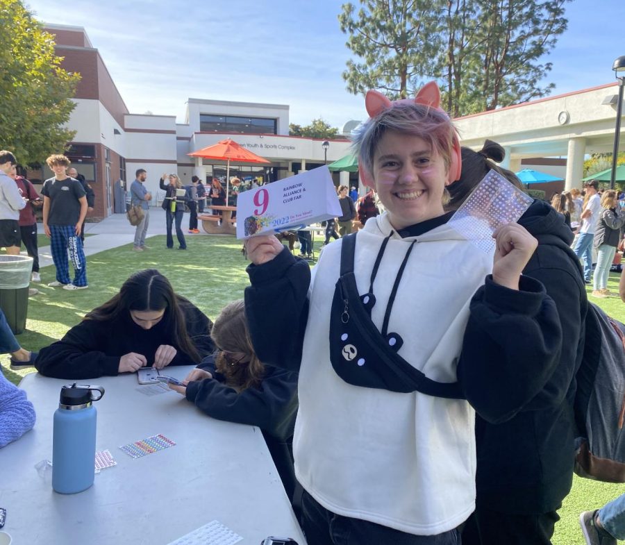 Nick H. (23) offers stickers and face painting at the 5th Annual Mental Health Fair Nov. 4, 2022, representing the Rainbow Alliance and Fight Against Racism (FAR) Clubs.
