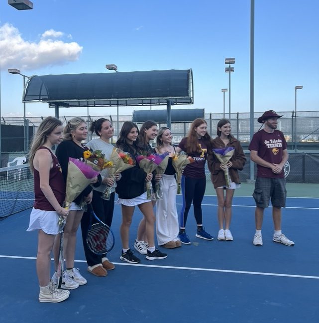 Girls tennis teams eight seniors: (from left to right) Alana W., Alexis G., Paige R., Emma S., Jane H., Michaela D., Darcy R., Charlotte H., and Coach Daniel Genud are honored for their hard work and dedication to dTHS athletics on Oct. 23, 2023, at Warner Center.