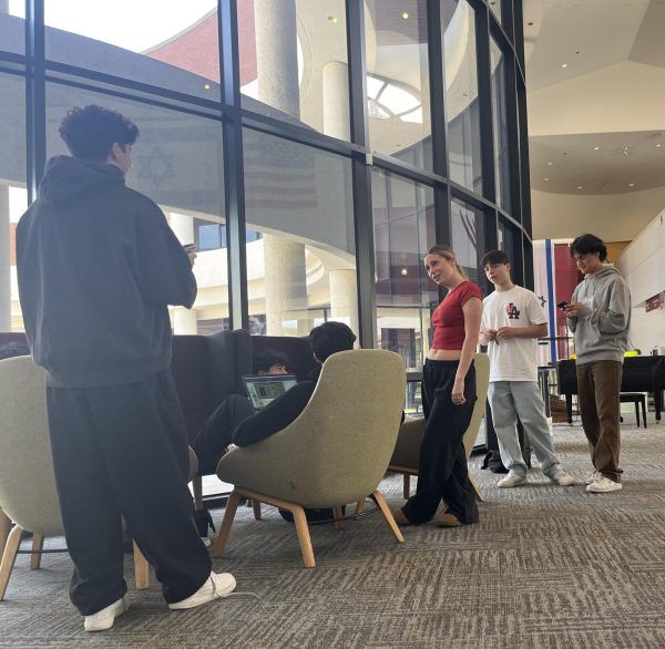 Look at our amazing Prowler team, working hard on their podcast! (Standing, left-right) Liam R., Ella S., Max B. and Daniel G. interview students in the dTHS lobby (March 29, 2024).
