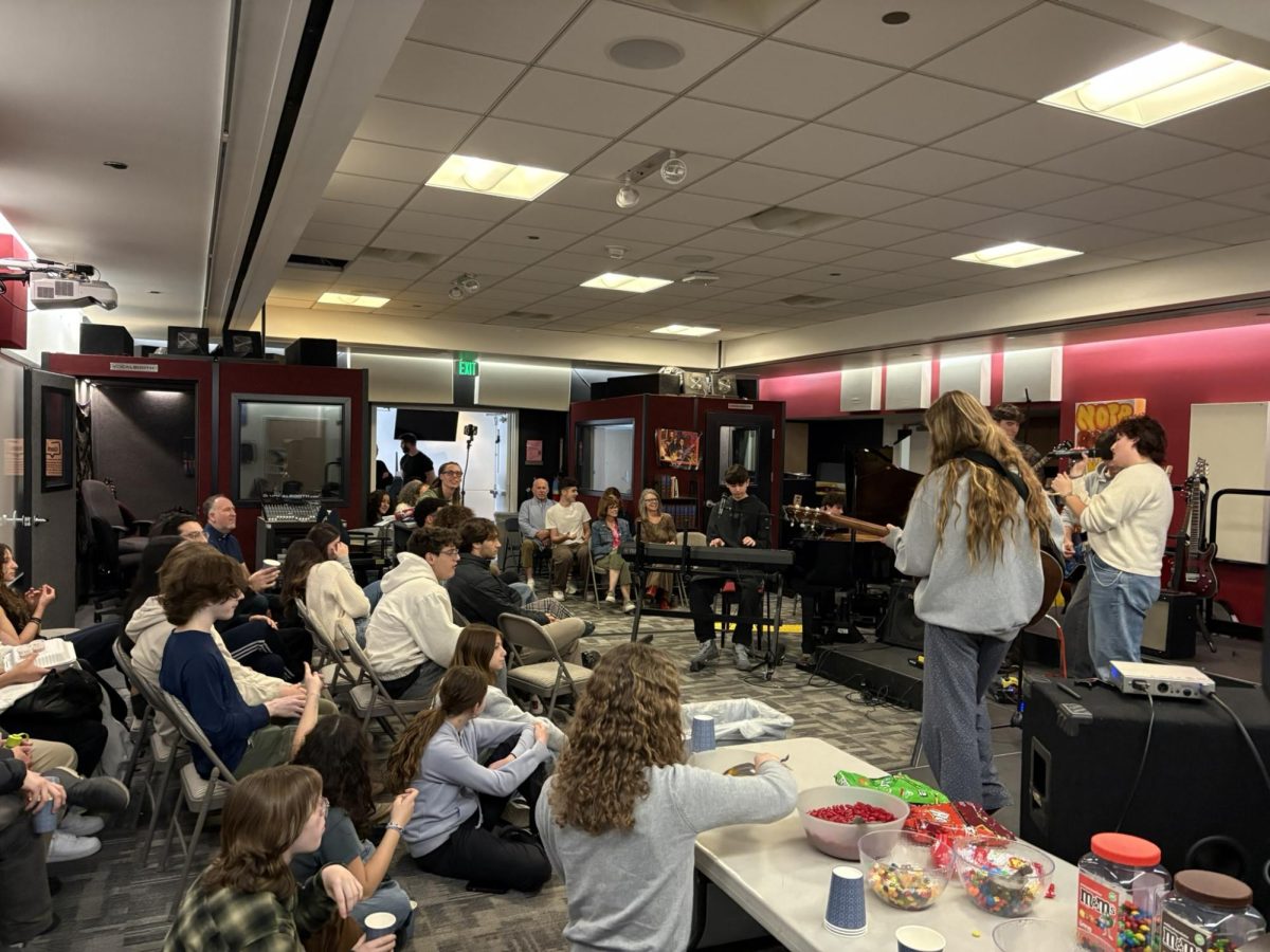 Students watch as members of the Pop Rock band Clay D ('25), Shelby L. ('27), Marlie G. ('25), Eytan F. ('25), Aidan R.('27), and Kiran C. ('26) participate in the most recent Lunch with the Arts program on Feb. 19, 2024. Mr. Stein is conducting the students through the songs.