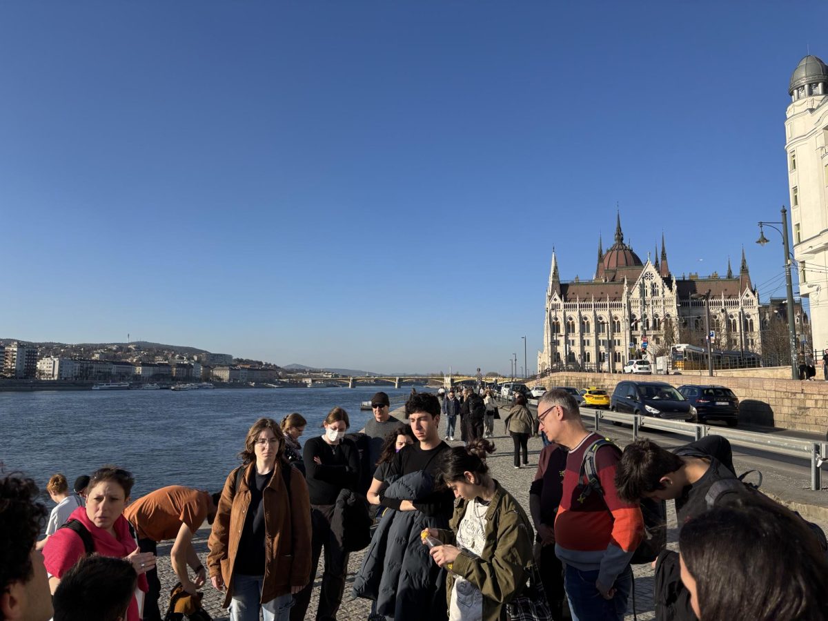 de Toledo seniors (from left) Rianna F., Aaron M.,  Eden R. and Dean of Students Greg Keer visit the Holocaust memorial outside the Budapest Parliament in Hungary during the Feb. 26-March 16, 2025, exchange program.