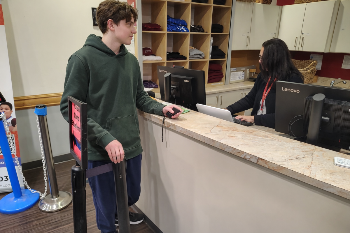 Theo U. ('28) purchases goods at the JagShack during lunch.