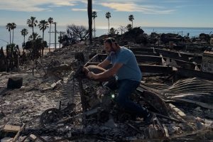 Nomi M.'s father on his motorcycle, destroyed in the fires.