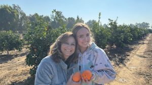 The Writer picks oranges on Kibbutz Be’eri with her grandmother Linda Lebovitz.
