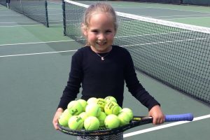 Author Shelby L. seen playing tennis as a young girl.